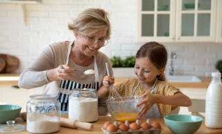 older-woman-working-in-kitchen-with-child
